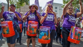 A Mujeres Unidas y Activas (MUA) street performance and march in Oakland, CA, 2021, as part of Y Basta Ya! (Enough!), an ongoing collaborative project initiated by NAKA Dance Theater to highlight stories of Indigenous and Latine immigrant women. Photo by 