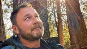 a photo of jason wise wearing a shirt with a rainbow on it