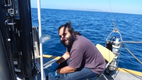 Babak Hassanzadeh doing research with the ocean behind him