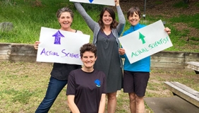 Oxy Biology department members with "Real Scientist" signs