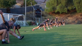 first year students warming up on the soccer field