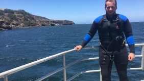 Ryan Freedman on boat with diving gear