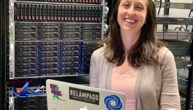 Melissa DeBiasse with laptop in server room