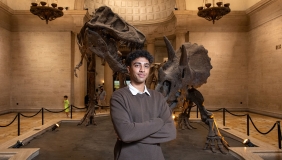Oxy student standing in front of an exhibit at the Natural History Museum