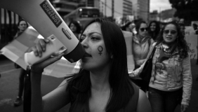 black and white photo of women protesting gender based violence in the street