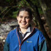 Woman in front of trees