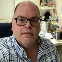Man in front of shelf
