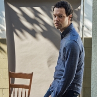 Instructor Max Foreman standing next to a chair