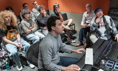 Curb Visiting Fellow Michael Lloyd, far right, and Resident Assistant Professor Max Foreman with Oxy students in the Choi Family Music Production Center.
