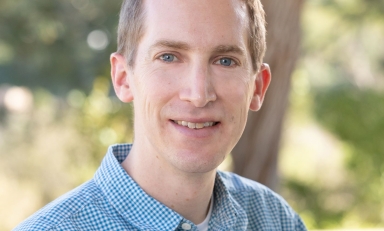 Dr. Brandon Taylor in front of a tree