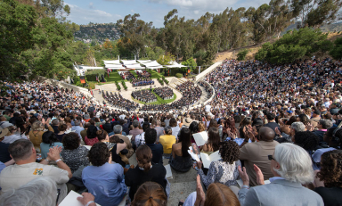A crowd full of people sititng in the Remsen Bird Hillside Theater at Commencement in 2025