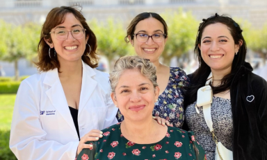 Dafna Erana Hernandez in a white coat with three women