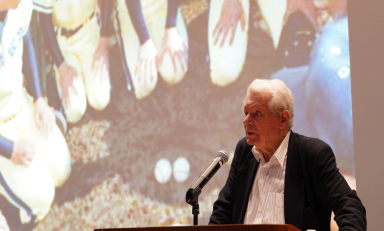 Image of Robert Whiting giving a presentation at a podium.