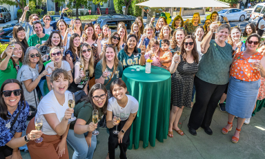 Members of Delta Omicron Tau spannng five decades raise a glass at the Delta House one last time on October 19.