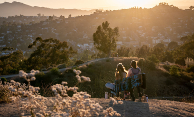 two Occidental students in a late afternoon sun-drenched scene on top of Fiji Hill at sunset
