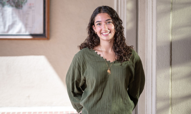 Aoife Mokalla ’28 standing against a wall with a green top
