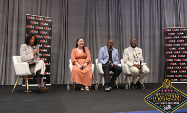 Awardees at the ceremony, four people seated on a stage