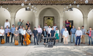 A wide-view image of the Music Dept faculty members posing as a group