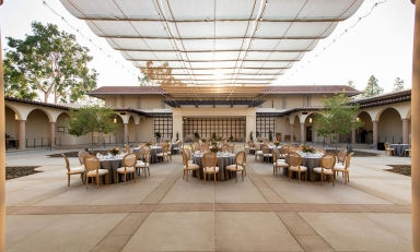 A view of Cannon Plaza set up with tables and chairs and place settings.