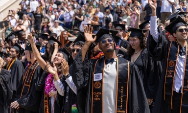 A scene on commencement day with a big crowd of happy graduates