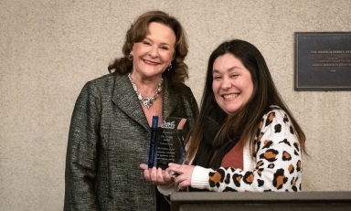 Lynn Mehl and Cori Vallembois pose with a SCIAC award