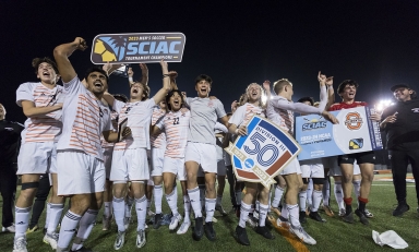 Oxy's men's soccer team celebrating on the field