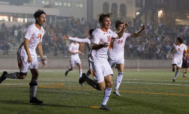 Occidental College men's soccer players in white jerseys out on the playing field