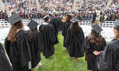 Occidental College graduating seniors in formation in the Greek Bowl, facing away from the camera