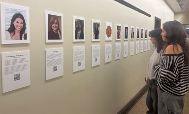 Spectators view the OCLAA oral history gallery in the Academic Commons in February 2024.