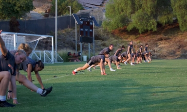 first year students warming up on the soccer field