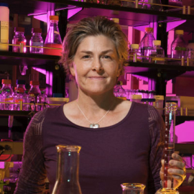 Woman in lab holding glassware