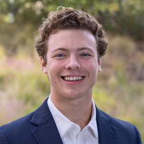 Thomas Quick headshot navy sports coat