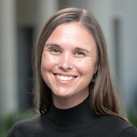 Angela Vawter headshot with long brown hair and black turtleneck