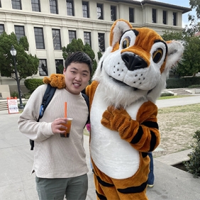Alex Woo and Oswald standing in front of a building at Occidental