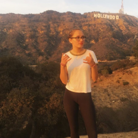 Olivia Oosterhout standing in fron tof the Hollywood sign