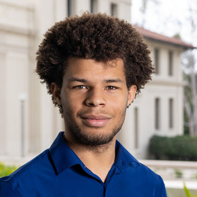 Jaymes Griggs cropped headshot blue shirt