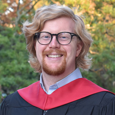 James Henderson headshot in graduation garb
