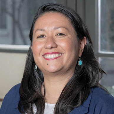 Carla Macal headshot in blue blazer