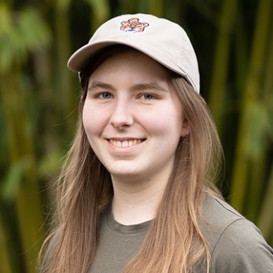 Mira Hart headshot wearing an Oxy baseball cap