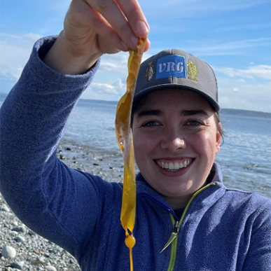 Miranda Roethler headshot with baseball cap and string of kelp