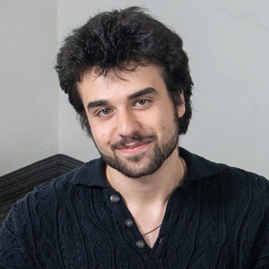 Occidental College student Peter Vartanian headshot in navy sweater