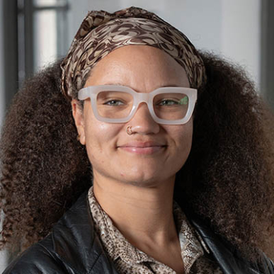 Summer Sloane-Britt headshot with big white glasses