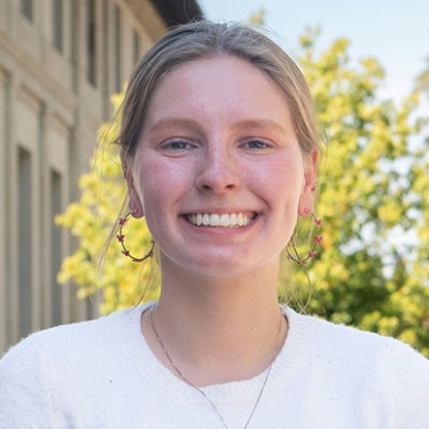 Amelia Muscott in front of the library