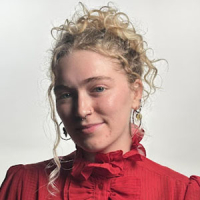 Ella Louise Alpert headshot with red collared top