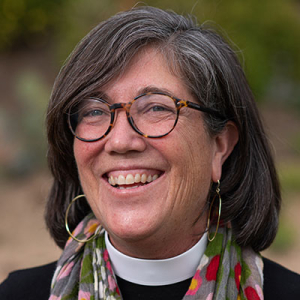 Carri Patterson Grindon headshot in a reverend's garb
