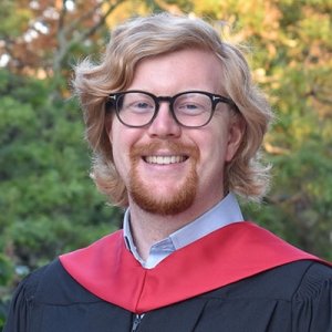 Oxy alumnus James Henderson in a graduation suit