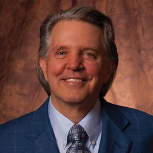 Mike Curb headshot in a blue suit