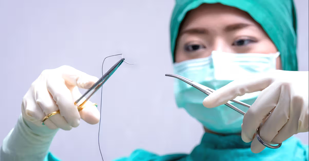 a doctor preparing suture equipment