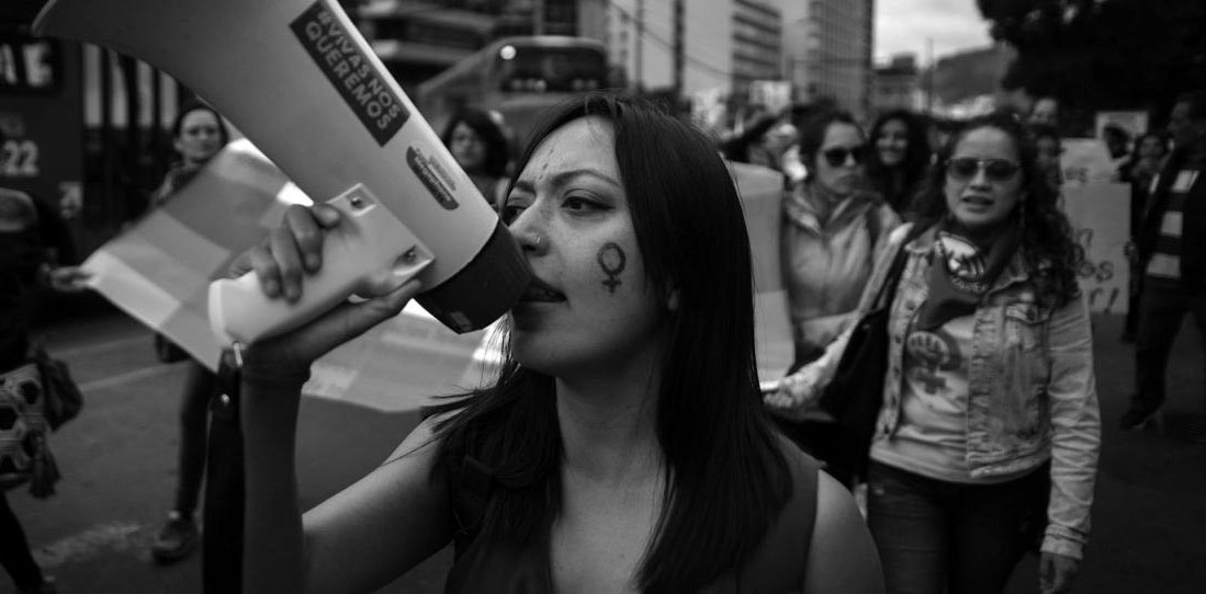 black and white photo of women protesting gender based violence in the street